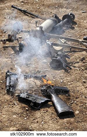 Pieces of enemy weapons lay out to cool off after being de-militarized. View Large Photo Image Picture - Pieces of enemy weapons lay out to cool off after being de-militarized.. Fotosearch