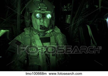 Pilot equipped with night vision goggles in the cockpit of a CH-47 Chinook. View Large Photo Image Picture - Pilot equipped with night vision goggles in the cockpit of a CH-47 Chinook.. Fotosearch