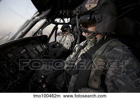 Pilot in the cockpit of a UH-60L Blackhawk helicopter. View Large Photo Image Picture - Pilot in the cockpit of a UH-60L Blackhawk helicopter.. Fotosearch