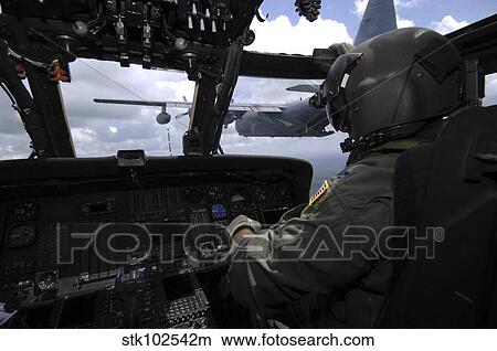 Picture - Pilot monitors the flight instruments in his HH-60 Pave Hawk.. Fotosearch