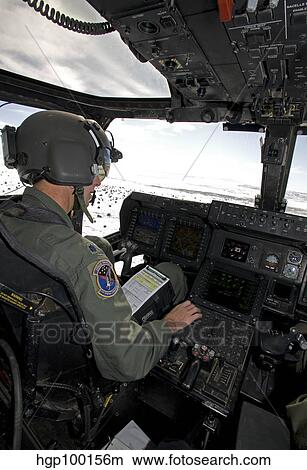 Pilot of a CV-22 Osprey goes over his instruments in the cockpit. View Large Photo Image Picture - Pilot of a CV-22 Osprey goes over his instruments in the cockpit.. Fotosearch