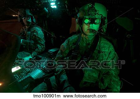 Pilots equipped with night vision goggles in the cockpit of a UH-60 Black Hawk. View Large Photo Image Picture - Pilots equipped with night vision goggles in the cockpit of a UH-60 Black Hawk.. Fotosearch