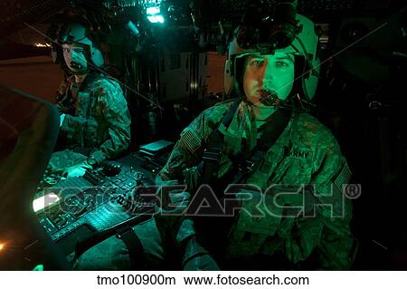 Pilots sitting in the cockpit of a UH-60 Black Hawk helicopter. View Large Photo Image Picture - Pilots sitting in the cockpit of a UH-60 Black Hawk helicopter.. Fotosearch