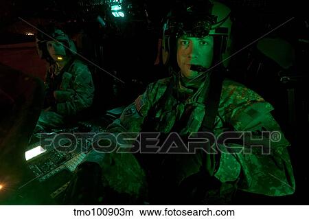 Pilots sitting in the cockpit of a UH-60 Black Hawk helicopter. View Large Photo Image Picture - Pilots sitting in the cockpit of a UH-60 Black Hawk helicopter.. Fotosearch