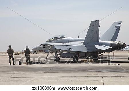 Pilots wait to board their F/A-18B Hornet trainer aircraft. View Large Photo Image Picture - Pilots wait to board their F/A-18B Hornet trainer aircraft.. Fotosearch