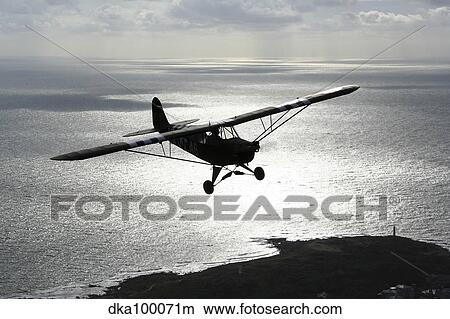 Piper L-4 Cub in US Army D-Day colors. View Large Photo Image Picture - Piper L-4 Cub in US Army D-Day colors.. Fotosearch