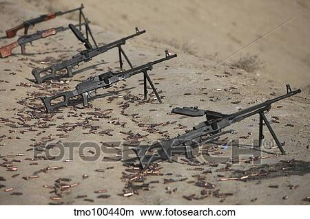 Picture - PK machine guns and spent cartridges at the firing range.. Fotosearch