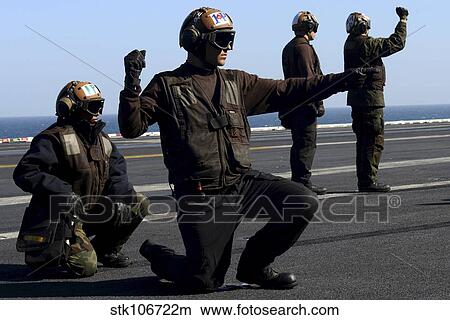 Plane captains signal for the start up of aircraft aboard USS John C. Stennis. View Large Photo Image Picture - Plane captains signal for the start up of aircraft aboard USS John C. Stennis.. Fotosearch