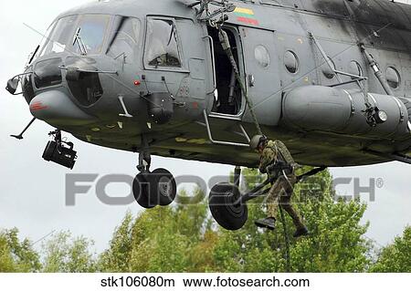Polish special forces member fast-ropes from a Lithuanian Mi-8 helicopter. View Large Photo Image Picture - Polish special forces member fast-ropes from a Lithuanian Mi-8 helicopter.. Fotosearch