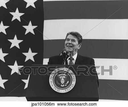 President Ronald Reagan speaking in front of a large American Flag. View Large Photo Image Picture - President Ronald Reagan speaking in front of a large American Flag.. Fotosearch