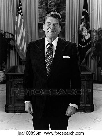 Picture - President Ronald Reagan standing in the Oval Office.. Fotosearch