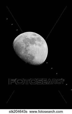 Progress of the International Space Station as it crosses the face of the moon. View Large Photo Image Stock Photograph - Progress of the International Space Station as it crosses the face of the moon.. Fotosearch