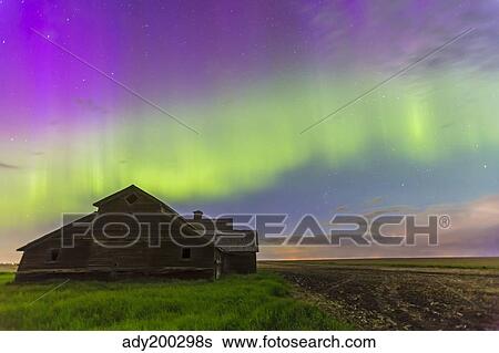 Stock Photograph - Purple aurora over an old barn in southern Alberta, Canada.. Fotosearch