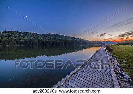 Quarter moon reflected in the waters of Reesor Lake, Alberta, Canada. View Large Photo Image Stock Photograph - Quarter moon reflected in the waters of Reesor Lake, Alberta, Canada.. Fotosearch