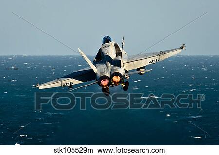 Rear view of an F/A-18C Hornet taking off. View Large Photo Image Picture - Rear view of an F/A-18C Hornet taking off.. Fotosearch