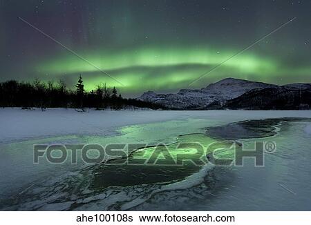 Stock Photograph - Reflected aurora over a frozen Laksa Lake, Nordland, Norway.. Fotosearch