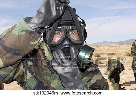 Rifleman puts on his gas mask. View Large Photo Image Picture - Rifleman puts on his gas mask.. Fotosearch