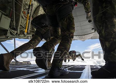 Romanian paratroopers perform a HALO jump out of a C-130J Super Hercules. View Large Photo Image Picture - Romanian paratroopers perform a HALO jump out of a C-130J Super Hercules.. Fotosearch