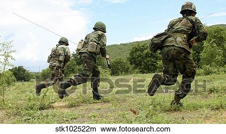 Royal Thai Marines rush forward to secure the site during an amphibious raid exercise. View Large Photo Image Picture - Royal Thai Marines rush forward to secure the site during an amphibious raid exercise.. Fotosearch