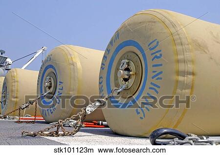 Rubber bladders full of drinking water wait for transport on the flight deck of USS Bataan. View Large Photo Image Picture - Rubber bladders full of drinking water wait for transport on the flight deck of USS Bataan.. Fotosearch