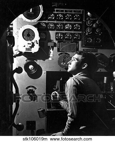 Sailor at work in the electric engine control room of USS Batfish. View Large Photo Image Picture - Sailor at work in the electric engine control room of USS Batfish.. Fotosearch