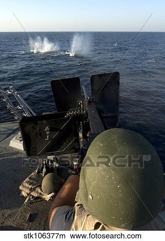Sailor fires a. 50-caliber machine gun aboard USS James E. Williams. View Large Photo Image Picture - Sailor fires a. 50-caliber machine gun aboard USS James E. Williams.. Fotosearch