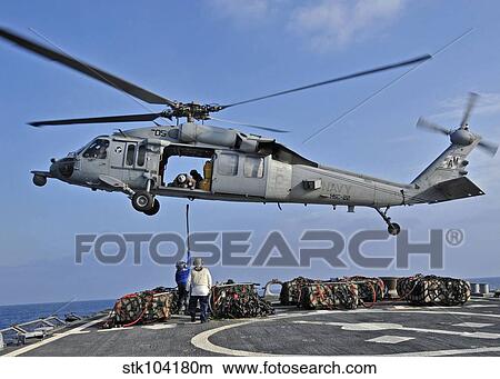 Sailors attach a cargo pennant to a MH-60S Sea Hawk helicopter. View Large Photo Image Picture - Sailors attach a cargo pennant to a MH-60S Sea Hawk helicopter.. Fotosearch