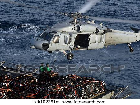 Sailors attach pallets of supplies to an MH-60S Knighthawk. View Large Photo Image Picture - Sailors attach pallets of supplies to an MH-60S Knighthawk.. Fotosearch