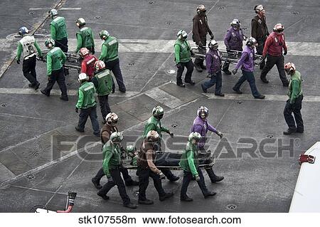 Sailors carry stretchers in response to a mass casualty drill. View Large Photo Image Picture - Sailors carry stretchers in response to a mass casualty drill.. Fotosearch