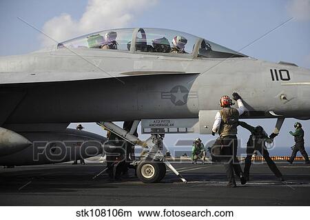 Picture - Sailors check an F/A-18F Super Hornet prior to take off.. Fotosearch