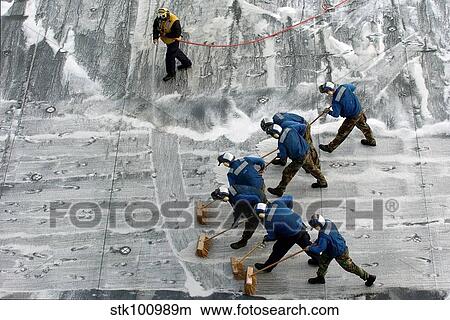 Sailors conduct a Scrub Exercise on the flight deck aboard USS Peleliu. View Large Photo Image Picture - Sailors conduct a Scrub Exercise on the flight deck aboard USS Peleliu.. Fotosearch