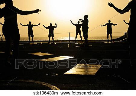 Sailors exercise in the hangar bay aboard USS Dwight D. Eisenhower. View Large Photo Image Picture - Sailors exercise in the hangar bay aboard USS Dwight D. Eisenhower.. Fotosearch