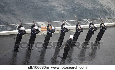 Sailors fire a 21-gun salute during a burial at sea ceremony. View Large Photo Image Picture - Sailors fire a 21-gun salute during a burial at sea ceremony.. Fotosearch