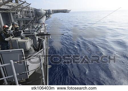 Sailors fire a 25mm machine gun aboard USS Bonhomme Richard. View Large Photo Image Picture - Sailors fire a 25mm machine gun aboard USS Bonhomme Richard.. Fotosearch