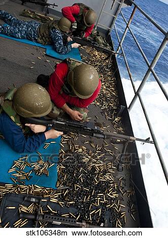 Picture - Sailors fire M240 machine guns on the fantail aboard USS John C. Stennis.. Fotosearch