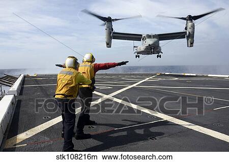 Sailors give an MV-22 Osprey flight directions. View Large Photo Image Picture - Sailors give an MV-22 Osprey flight directions.. Fotosearch