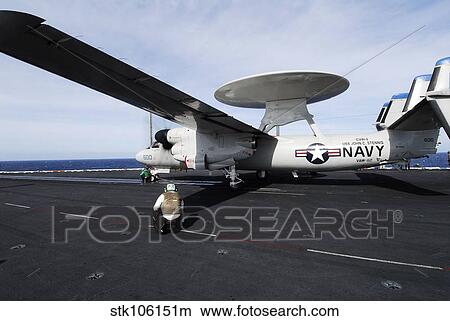Sailors guide an E-2C Hawkeye to a steam driven catapult. View Large Photo Image Picture - Sailors guide an E-2C Hawkeye to a steam driven catapult.. Fotosearch
