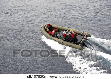 Sailors in a rigid-hull inflatable boat conduct boat operations. View Large Photo Image Picture - Sailors in a rigid-hull inflatable boat conduct boat operations.. Fotosearch