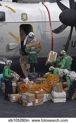 Sailors load mail on to a C-2A Greyhound. View Large Photo Image Picture - Sailors load mail on to a C-2A Greyhound.. Fotosearch