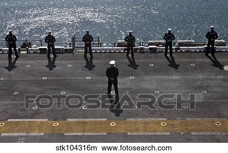 Sailors man the rails on the amphibious assault ship USS Essex. View Large Photo Image Picture - Sailors man the rails on the amphibious assault ship USS Essex.. Fotosearch