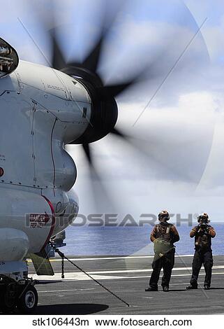 Sailors monitor an E2-C Hawkeye on the flight deck of USS Nimitz. View Large Photo Image Picture - Sailors monitor an E2-C Hawkeye on the flight deck of USS Nimitz.. Fotosearch