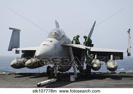 Sailors perform maintenance on an F/A-18F Super Hornet. View Large Photo Image Picture - Sailors perform maintenance on an F/A-18F Super Hornet.. Fotosearch