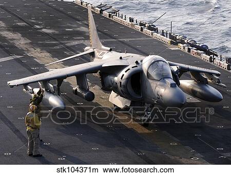 Sailors prepare an AV-8B Harrier jet aircraft for take-off from USS Essex. View Large Photo Image Picture - Sailors prepare an AV-8B Harrier jet aircraft for take-off from USS Essex.. Fotosearch