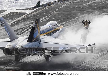 Sailors prepare an F/A-18C Hornet to launch from USS Nimitz. View Large Photo Image Picture - Sailors prepare an F/A-18C Hornet to launch from USS Nimitz.. Fotosearch