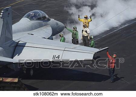 Sailors prepare an F/A-18F Super Hornet for launch. View Large Photo Image Picture - Sailors prepare an F/A-18F Super Hornet for launch.. Fotosearch