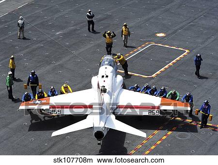 Sailors push a T-45C Goshawk on the flight deck of USS Ronald Reagan. View Large Photo Image Picture - Sailors push a T-45C Goshawk on the flight deck of USS Ronald Reagan.. Fotosearch