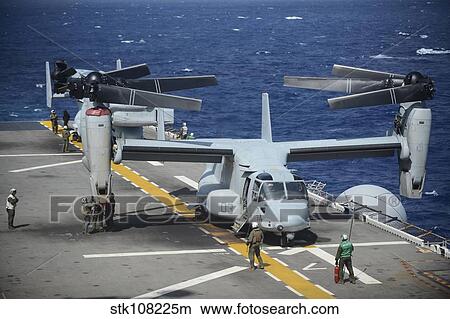 Sailors secure an MV-22 Osprey tiltrotor aircraft. View Large Photo Image Picture - Sailors secure an MV-22 Osprey tiltrotor aircraft.. Fotosearch