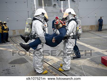 Sailors simulate rescuing a pilot during a crash and salvage drill. View Large Photo Image Picture - Sailors simulate rescuing a pilot during a crash and salvage drill.. Fotosearch