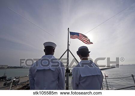 Sailors stand by to lower the ensign on USS John C. Stennis. View Large Photo Image Picture - Sailors stand by to lower the ensign on USS John C. Stennis.. Fotosearch