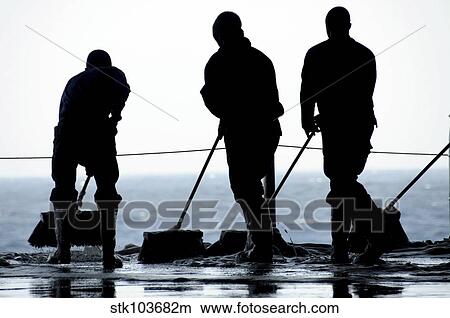 Sailors sweep out the hangar bay aboard the aircraft carrier USS Nimitz. View Large Photo Image Picture - Sailors sweep out the hangar bay aboard the aircraft carrier USS Nimitz.. Fotosearch